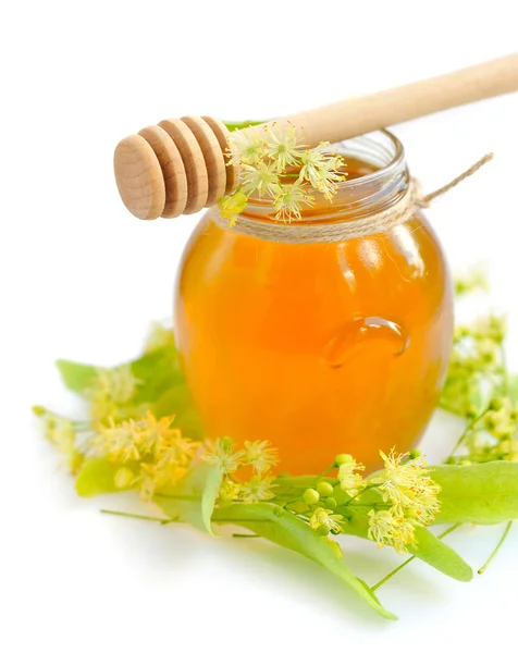 Jar of fresh honey with flowers of linden on white background — Stock Photo, Image