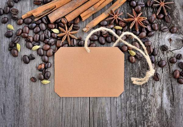 Blank paper sticker with roasted coffee beans on old wooden background — Stock Photo, Image
