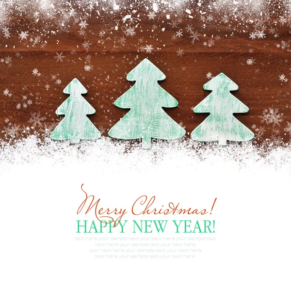 Wooden christmas trees on snow wooden background. Christmas card — Stock Photo, Image