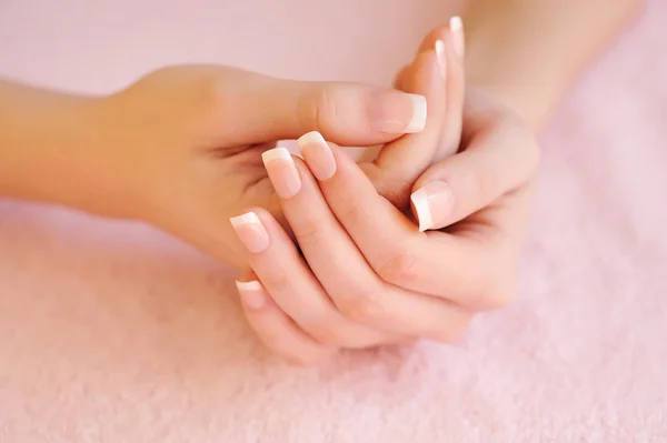 Mãos de mulher com bela manicure francesa — Fotografia de Stock