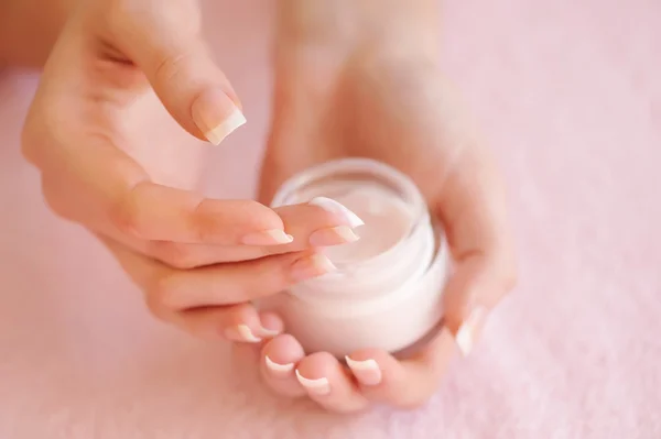 Beautiful woman hands with cream — Stock Photo, Image