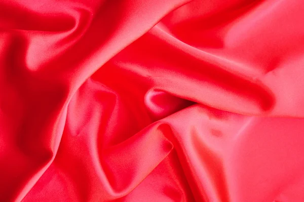 Tecido de cetim ou seda vermelho como fundo — Fotografia de Stock