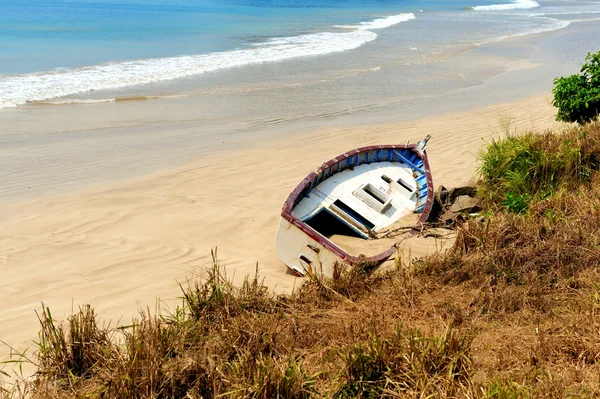 Old yacht stranded on a beach