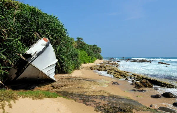 Old yacht stranded on a beach