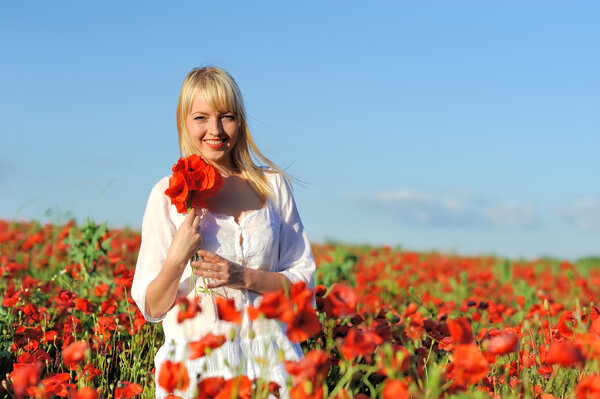 Young beautiful girl in the poppy