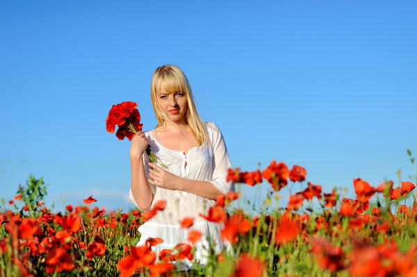 Young beautiful girl in the poppy