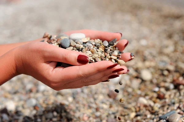 Hands dropping small stones — Stock Photo, Image