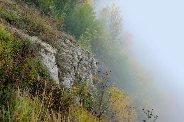 Hill in the sunrise misty fog and clouds — Stock Photo, Image