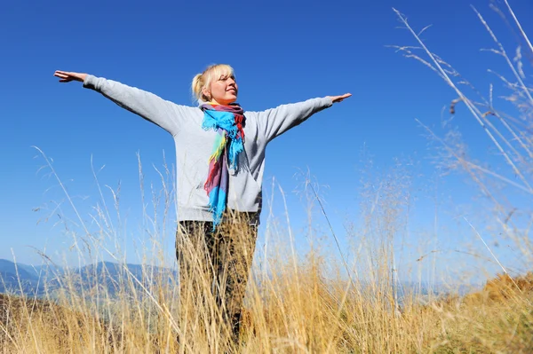 Woman in autumn mountain Stock Photo