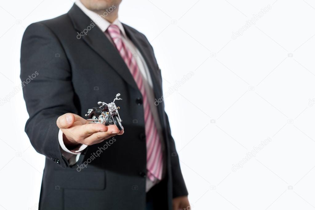 Man in office with toy motorcycle