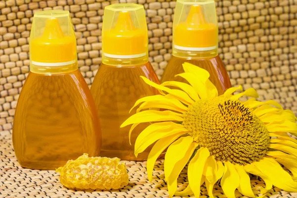 Honig im Glas und Sonnenblumen — Stockfoto