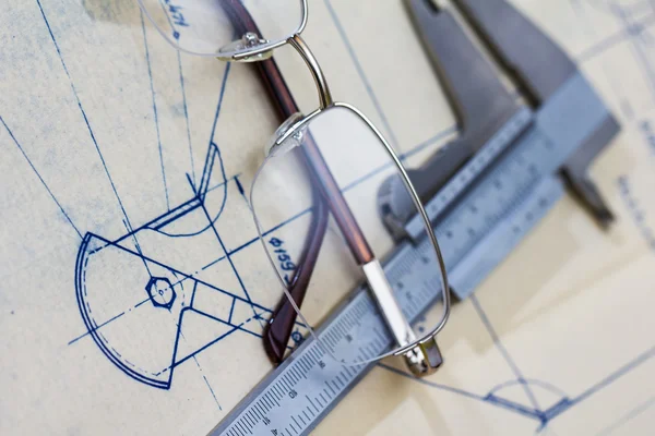 Engineering blueprint with glasses and gauge — Stock Photo, Image