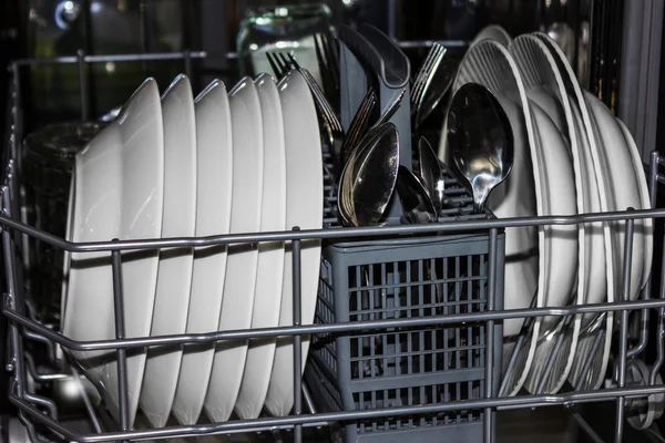 Kitchen dishwasher with plates, forks and spoons — Stock Photo, Image