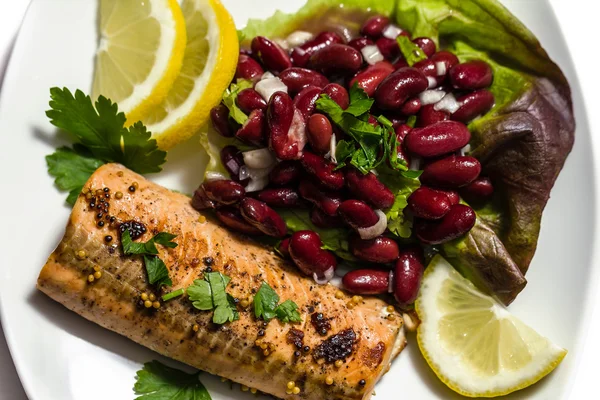 Salmon fillet grilled with bean salad, lemon and parsley — Stock Photo, Image