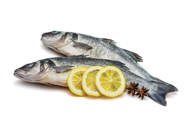 Sea bass fish whit lemon and star anise on withe background — Stock Photo, Image