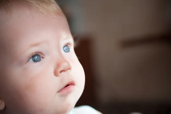 Pequeno bebê loiro bonito está olhando para cima — Fotografia de Stock