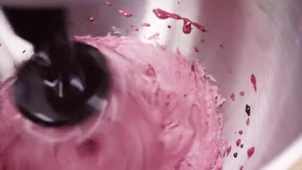 Fondo colorido. El batidor de la batidora bate la crema. Fondo rosa. Artículos de confitería, producción, herramientas de cocina — Vídeos de Stock