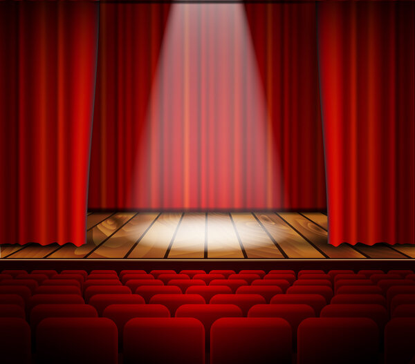 A theater stage with a red curtain