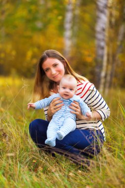 Mutlu genç beyaz anne ve oğlu açık havada park