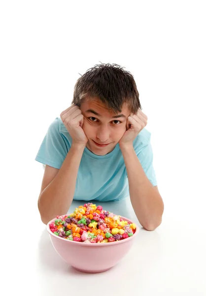 Boy relaxes with bowl of snack food — Stock Photo, Image