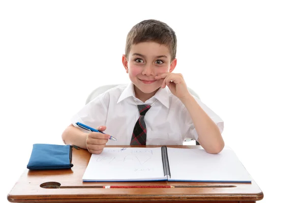 Uczeń szkoły chłopiec na biurko — Zdjęcie stockowe
