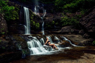 Çalı kaldırımından sonra şelalede güneşlenen güzel bir kadın..