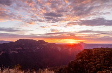 Avustralya 'nın Mavi Dağları' nın dağ sıralarının ve uçurumlarının ardında gün doğumu