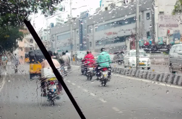 View of  Indian road traffic during rain background