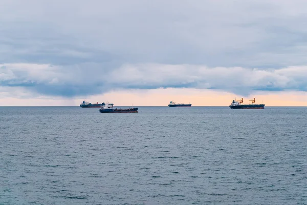 Four merchant ships on calm waters at sea