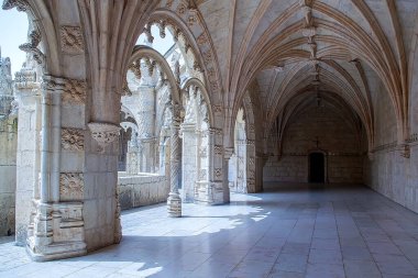 Portekiz, Lizbon - 05 Ağustos 2018: UNESCO Dünya Mirası sahasında detaylı oymalar, sivri kemerler, yeşil çimenler, patikalar ve fıskiyeler içeren iki katlı manastır mimarisi, Portekiz Gotik tarzını sergiliyor. Yüksek kalite fotoğraf.