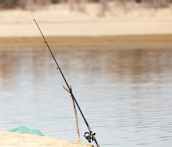 Fishing rod on the river bank — Stock Photo, Image