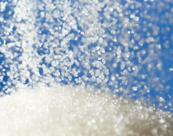 Sugar on a blue background — Stock Photo, Image