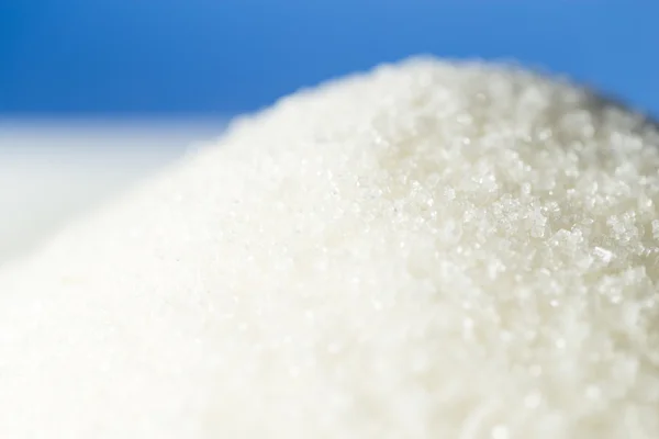 Sugar on a blue background — Stock Photo, Image