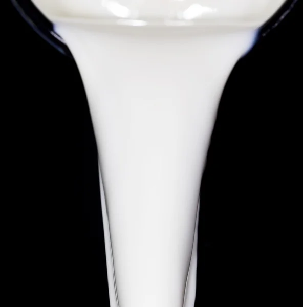 Milk on a black background — Stock Photo, Image