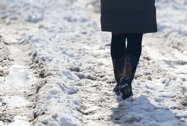 Niña en botas de invierno caminando por el camino nevado — Foto de Stock