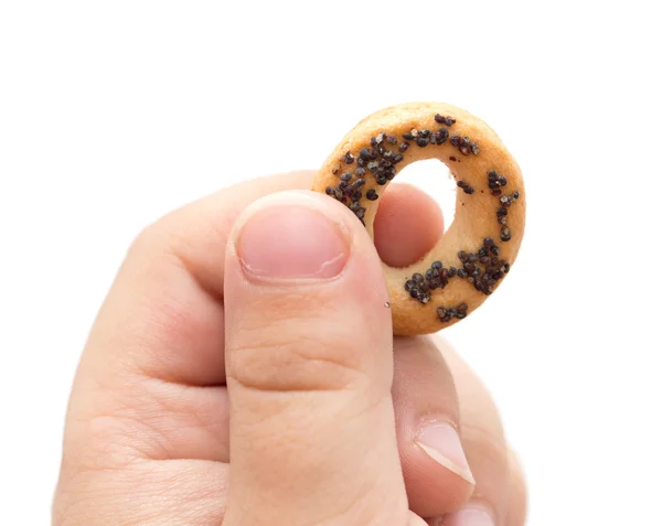 Bagel in the children 's hand on white — стоковое фото