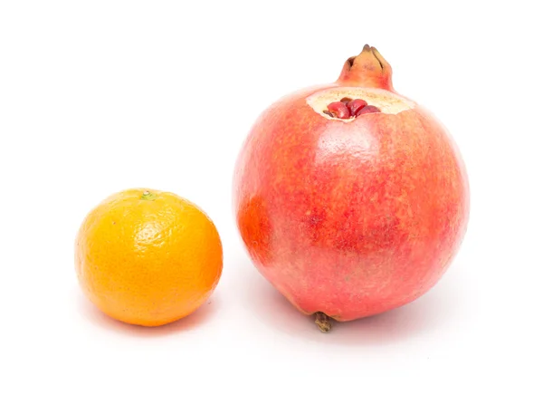 Pomegranate and tangerine on a white background — Stock Photo, Image