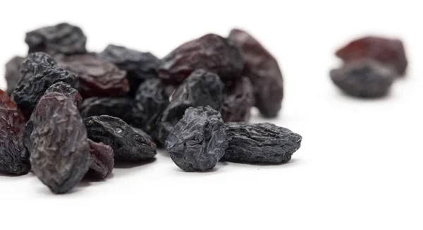 Black raisins as background. macro — Stock Photo, Image