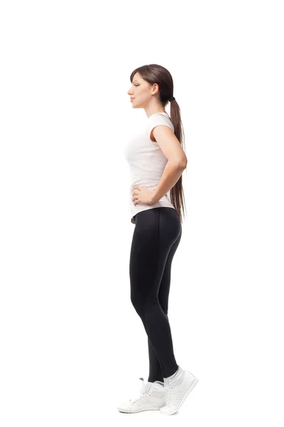 Mulher fitness em estilo desportivo em pé contra fundo branco. isolado — Fotografia de Stock