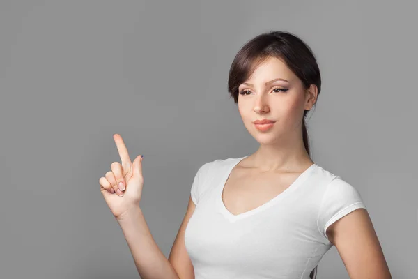 Beautiful young woman pointing her finger blank space — Stock Photo, Image