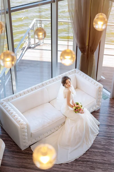 Beautiful bride against a big window indoors — Stock Photo, Image