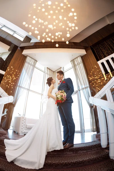 Bir pencere karşı duran genç Düğün çifti