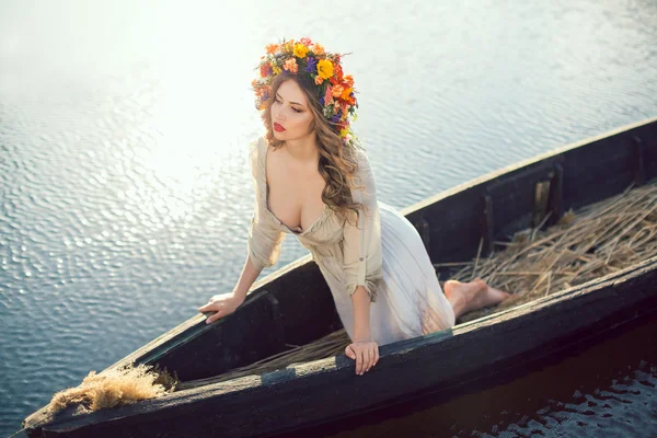 Fantasy art photo of a beautiful lady lying in boat