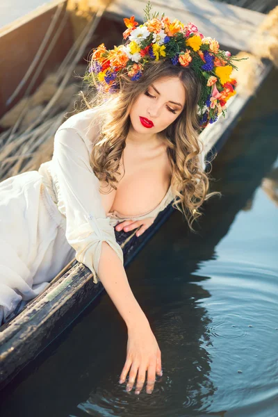 Beautiful girl lying in boat — Stock Photo, Image