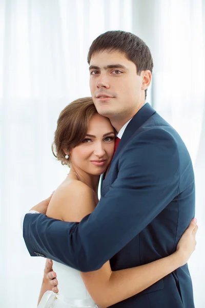 Bride and groom in very bright room at home — Stock Photo, Image