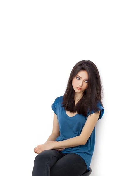 Young bored upset woman sitting on chair — Stock fotografie