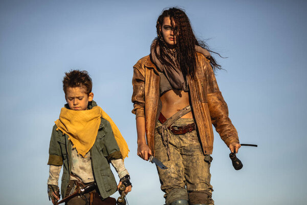 Post Apocalyptic Woman and Boy Outdoors in the Wasteland