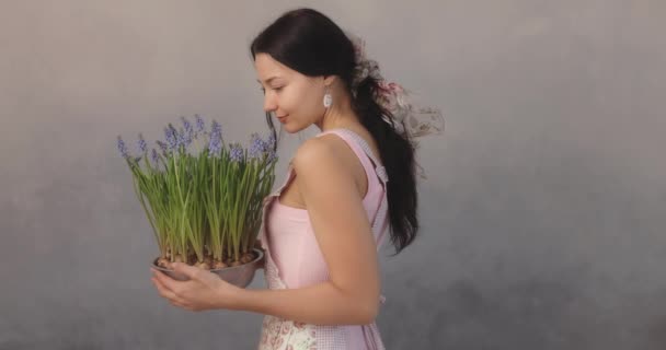 Woman Holding Bouquet of Flowers in Hands Indoors — Stock Video