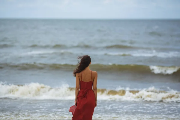 Woman in a Red on the Beach, Cold Windy Weather — Stock Photo, Image