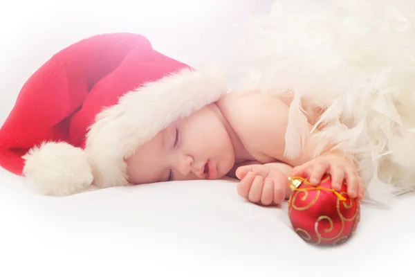 Маленький хлопчик спить у новорічній шапці Стокова Картинка